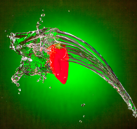 Water Splashes on Red Mini Bellの写真素材