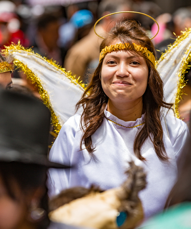 Cuenca, Ecuador - Dec 24, 2014: Woman dresses as angel in Paseo del Nino Paradeのeditorial素材