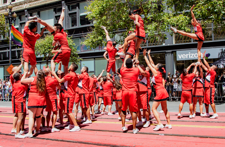 SAN FRANCISCO, CALIFORNIA, JUNE 24, 2018:  GAY PRIDE PARADE - Acrobats perform aerial stunts while marchingのeditorial素材