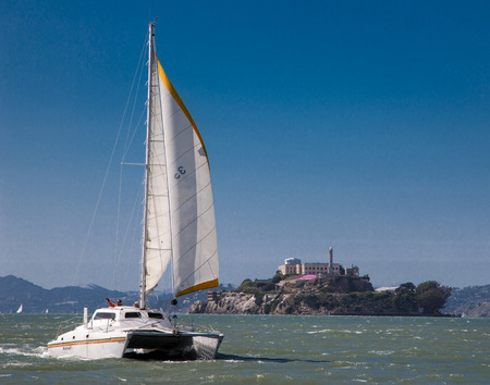 San Francisco, Calif / May 27, 2012 : Catamaran sails on bay past Alcatrazのeditorial素材