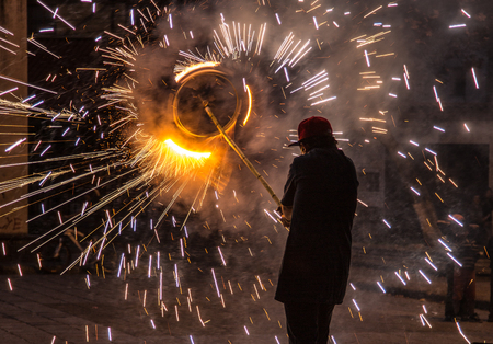 Cuenca, Ecuador / Nov 29, 2012: Man holds fireworks pinwheel at the end of a bamboo pole