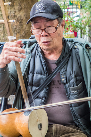 New York, New York / Nov 4, 2014: Man plays traditional Chinese musical instrumentのeditorial素材