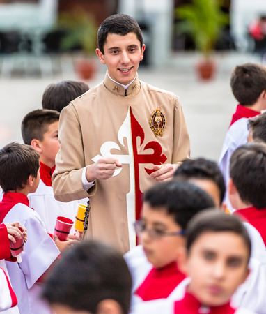 Cuenca, Ecuador / June 4, 2015 - Catholic Curate (priest trainee) talks to young boys prior to...