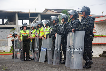 Cuenca, Ecuador / August 13, 2015 - Riot police stand in formation, guarding against potential...