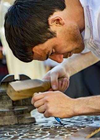 Tashkent, Uzbekistan / May 18, 2017 - Artisan creates fine art with wood using chiselのeditorial素材