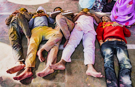 Barsana, India / February 23, 2018 - Five men catch some sleep on the floor of a temple during Holi festivalのeditorial素材