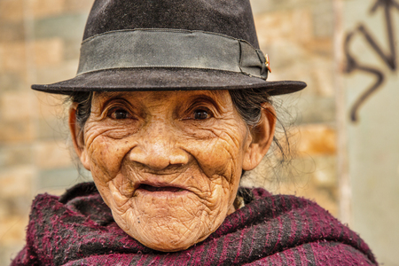 Latacunga, Ecuador - September 22, 2018 - Old woman watches Mama Negra paradeのeditorial素材
