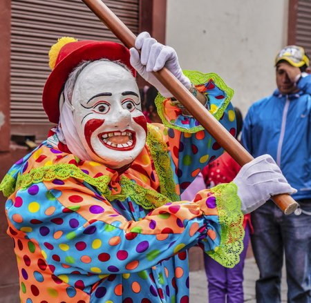 Latacunga, Ecuador - September 22, 2018 - A clown leads each neighborhood group in the Mama Negra...