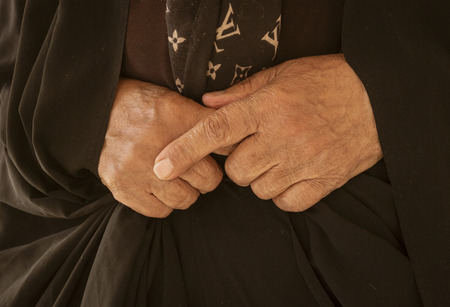 Woman hands are folded in peaceful reflectionの写真素材