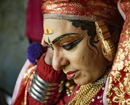 Munnar, India, Mar 11, 2018 - Traditional Indian dancer adjusts his costume prior to showのeditorial素材
