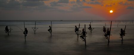 Galle, Sri Lanka - 2019-04-01 - Stilt Fishermen of Sri Lanka Spend All Day on Small Platforms to Catch Fish for Dinner.のeditorial素材