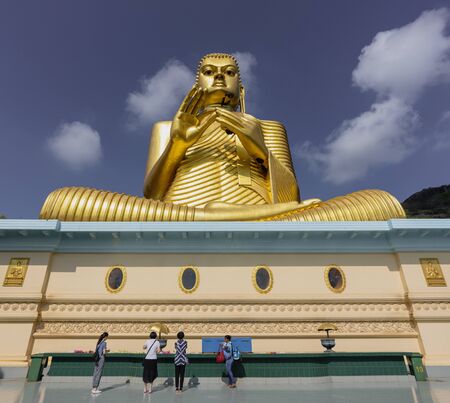 Kandy, Sri Lanka - 09-03-24 - Giant Golden Buddha Statue at Golden Temple of Dambulla in Sri Lanka.のeditorial素材