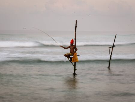 Galle, Sri Lanka - 2019-04-01 - Stilt Fishermen of Sri Lanka Spend All Day on Small Platforms to Catch Fish for Dinner.のeditorial素材