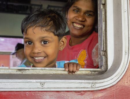 Kandy, Sri Lanka - 09-03-24 - Mother and Child Look Out of Train Window.のeditorial素材
