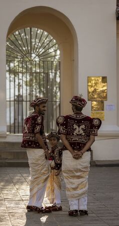 Kandy, Sri Lanka - 09-03-24 - Two Men and a Boys Wait for Wedding Couple.のeditorial素材