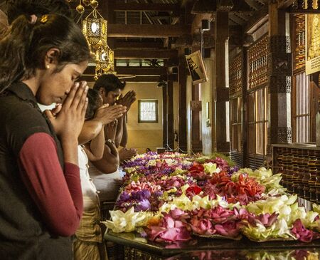 Kandy, Sri Lanka - 09-03-24 - People Place Flowers on Dais and Then Pray to Hindu Gods.のeditorial素材