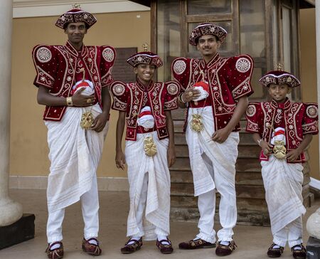 Kandy, Sri Lanka - 09-03-24 - Two Men and Two Boys Wait for Wedding Couple.のeditorial素材