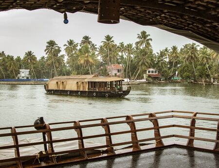 ALLEPPEY, INDIA, MAR 13, 2018: Bamboo thatched houseboat floats down the backwaters of Keralaのeditorial素材