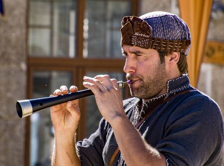 Penedono , Portugal - July 1, 2017 - Man plays Shawn woodwind instrument in annual Medieval fairのeditorial素材