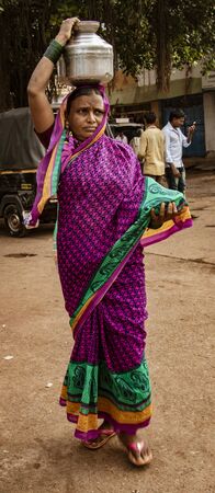 BADAMI, INDIA, MAR 18, 2018: Woman carries her load on her headのeditorial素材