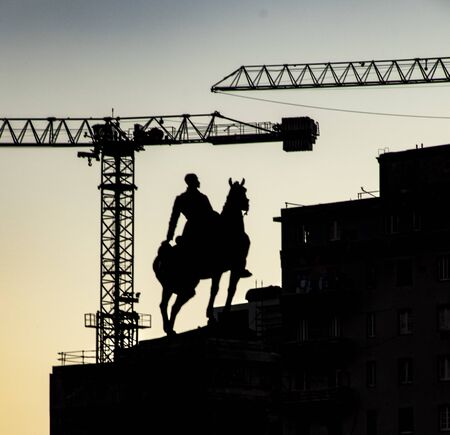 Havana, Cuba Nov 19, 2017 - Construction cranes and a war memorial stature can be seen over Havana skyline at duskのeditorial素材