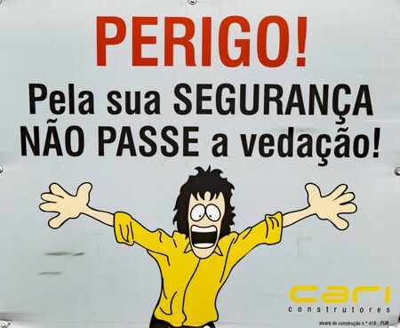 Porto, Portugal - June 21, 2017 - Cartoon on sign says - Danger For your safety, do not overdo itのeditorial素材