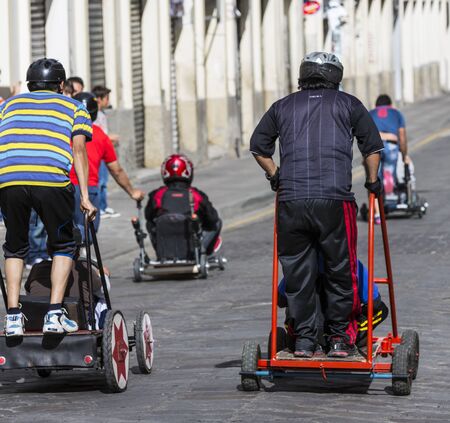 Cuenca, Ecuador - April 12, 2015 - Teenage boys race their home-built soap box cars during...