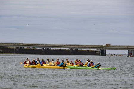 Moss Beach, California - June 17, 2018: Kayakers gather in the middle of the river to discuss plans in Californiaのeditorial素材