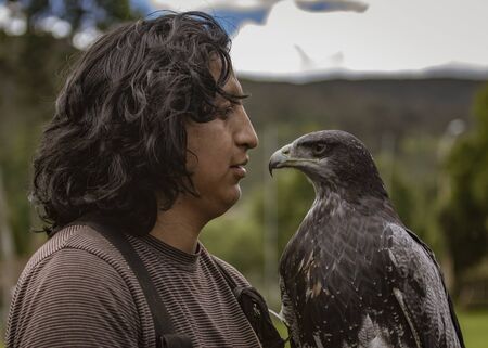 Gualaceo, Ecuador - June 1, 2018: A man holds a bird of prey at an ecological rescue center in Ecuadorのeditorial素材