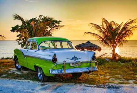 Trinidad, Cuba, Nov 28, 2017 - Green and white 1950 s Class America  Ford Fairlane parked on beachのeditorial素材
