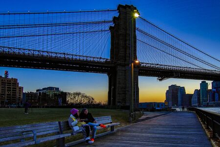 BROOKLYN, NEW YORK, MAR 27, 2018: Brooklyn Bridge, seen from Dumbo Park after sunset, during the  Blue Hourのeditorial素材
