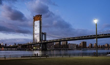 BROOKLYN, NEW YORK, MAR 27, 2018: Manhattan Bridge, as seen from Dumbo Park during twilightのeditorial素材