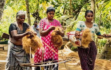 MONROE ISLAND, INDIA, MAR 15, 2018: Women spin coconut hair by hand, turning it into a strong rope