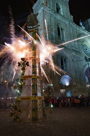 Cuenca, Ecuador - June 1, 2018: A fireworks castle is fired in front of a church in Cuenca, Ecuador