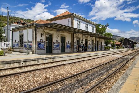 Pinhao, Portugal - June 27, 2017 - Train tracks lead into station with famous mural tilesのeditorial素材