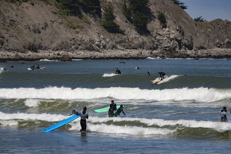 Pacifica, California - June 16, 2018: Surfers and paddle-boards compete for the few waves on this beach in Californiaのeditorial素材