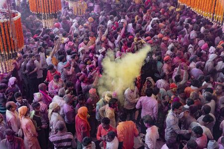 Barsana, India, Holi Festival, Feb 24, 2018 - Crowds can be seen below duirng Holi Festival in India, throwing powdered paintのeditorial素材