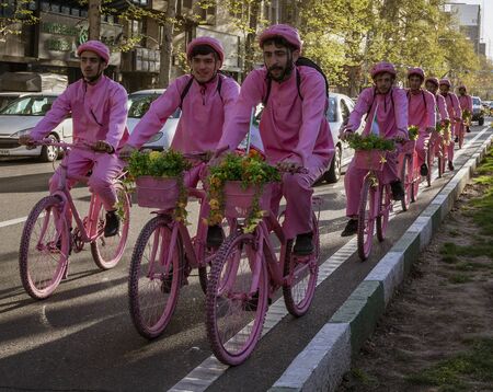 Tehran, Iran - 2019-04-03 - Men ride bicycles in pink to promote new bike rental company.のeditorial素材