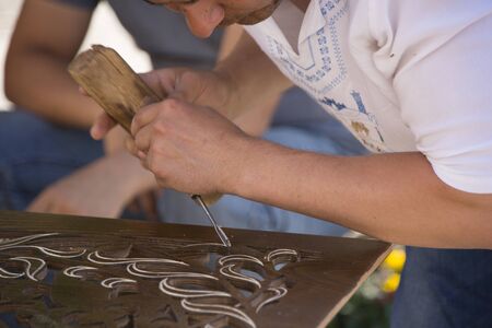 Tashkent, Uzbekistan - May 18, 2017 - Artisan creates fine art with wood using chiselのeditorial素材