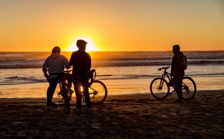 La Serena, Chile - 2019-06-29 - People silhouetted at sunset on the beach.のeditorial素材