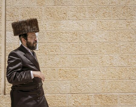 Jerusalem, Israel - 2019-04-26 - orthodox Jew walks in front of wall.のeditorial素材