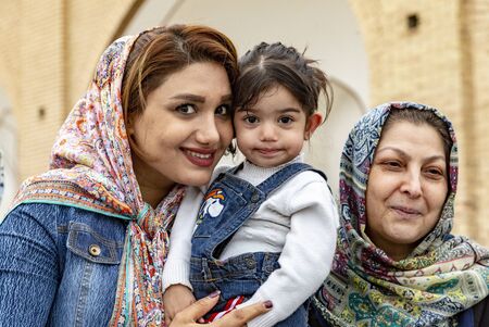 Kashan, Iran - 2019-04-14 - Naqshe Cehan Square three generations pose for the foreign photographer.のeditorial素材