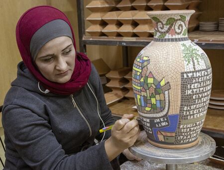 Petra, Jordan - 2019-04-20 - Woman creates intricate mosaic vase.のeditorial素材