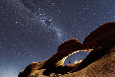 Milky Way shines over an arch in the desert in Namibiaの写真素材