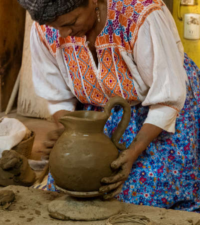 Sant Matin Ticajete, Mexico - 2019-11-26 - woman makes clay pitcher using traditional methods with no pottery wheel.のeditorial素材