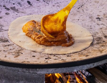 A chile relleno is made over an open fire.の写真素材