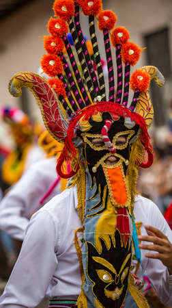 Cuenca, Ecuador - December 24, 2015 - Man wears devil costume in Paseo de Nino paradeのeditorial素材