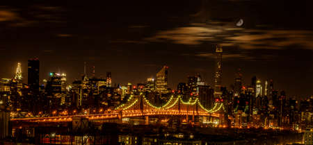 BROOKLYN, NEW YORK, MAR 27, 2018: Queensboro Bridge seen at night with the moon overheadのeditorial素材