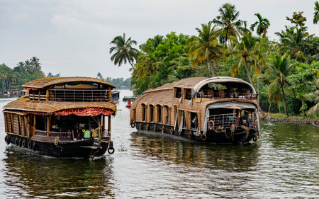 ALLEPPEY, INDIA, MAR 13, 2018: Bamboo thatched houseboat floats down the backwaters of Keralaのeditorial素材