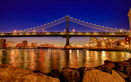 BROOKLYN, NEW YORK, MAR 27, 2018: Manhattan Bridge, as seen from Dumbo Park an hour after sunset,...